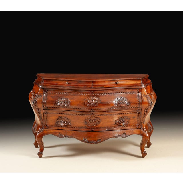 This original Italian antique Bombay chest is crafted entirely in solid walnut and distinguished by its graceful bomb...