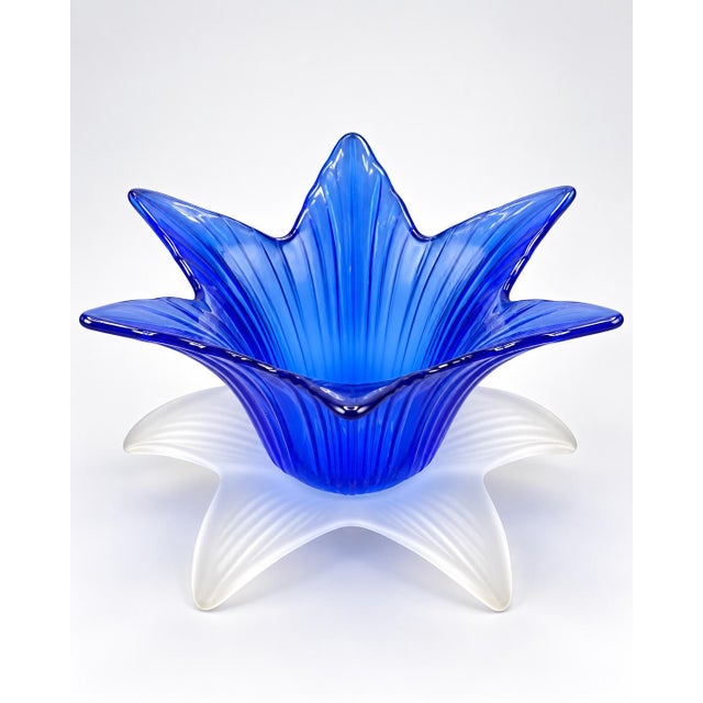 Striking vintage cobalt blue sculptural art glass bowl featuring a dramatic flower-form design with a frosted clear-to-...