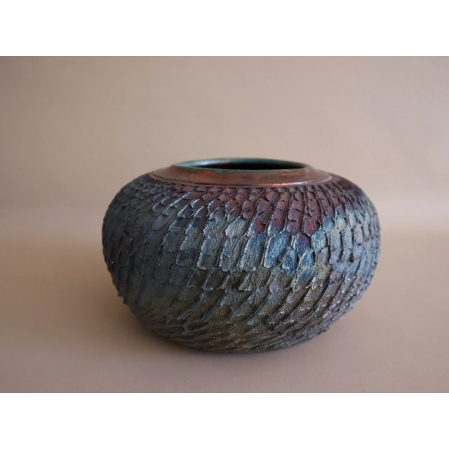 Beautiful textured vase by Hawaiian ceramic artist, Robbrecht Troost. Beautiful hues of teal, royal blue and bronze.