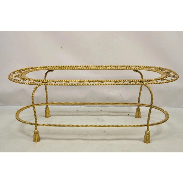 Vintage Italian Hollywood Regency Gold Gilt Iron Oval 2 Tier Rope Tassel Coffee Table. Item features 2 tiers (does not...