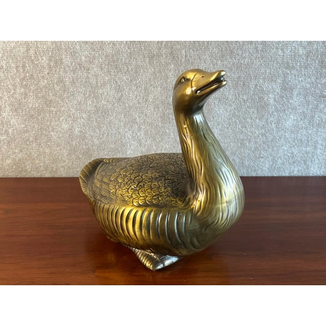 Vintage Mid 20th Century brass goose or duck made of thick, hollow brass that has been lacquered to prevent tarnishing....