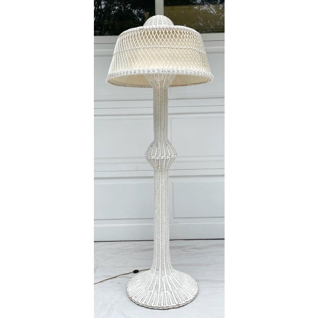 Here is an incredible, statement floor lamp! It is made of woven wicker and painted in a neutral white. I love the shape...