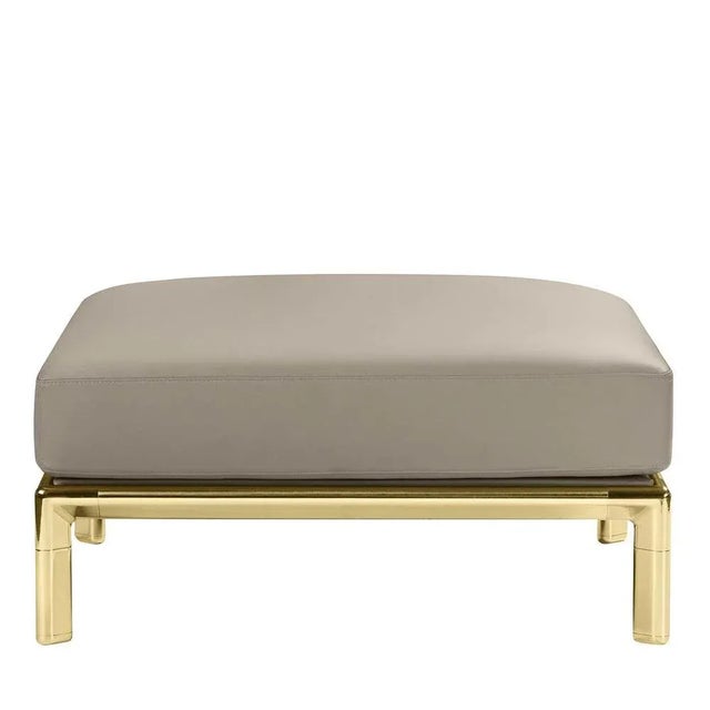 This square, low ottoman rests on polished- or satin-brass legs and features a fabric-colored seat. It is part of the...