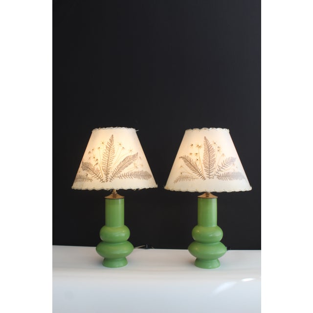 Pair of Jean Roger Style ceramic lamps with botanical fiberglass shades. Vibrant chartreuse glaze. Shades hand pressed...