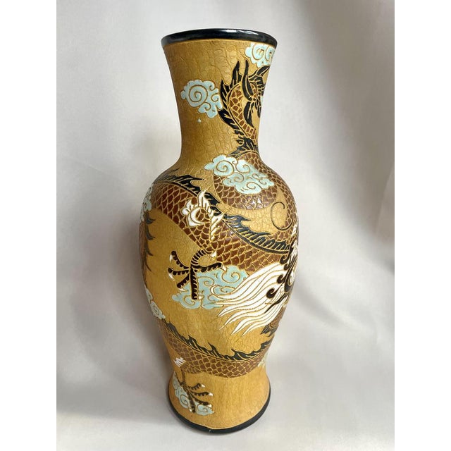 Substantial ceramic Dona vase featuring an intricate dragon and cloud motif, hand-decorated. This impressive piece, signed...