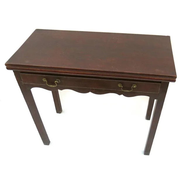 English mahogany one drawer flip top tea table. Shaped apron, straight chamfered legs. Brass bail pulls.180016x 34 x 29...