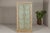 An Almirah armoire made from reclaimed wood, with weathered green patina, three interior shelves and carved décor....