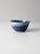 A vintage studio pottery bowl, signed by the artist. The hand-crafted form features a rich blue glaze with a softly...