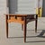 Mid-Century Modern solid wood side table by Red Lion Table Co., featuring a warm wood finish, tapered legs, a single...