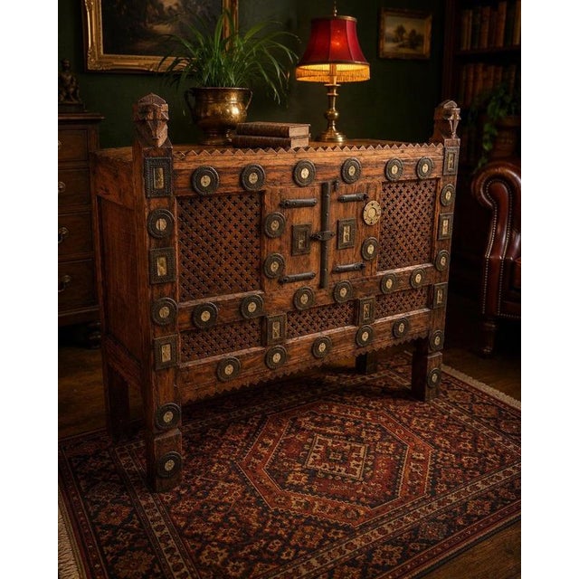 A striking and highly decorative handmade Indian wooden cabinet, distinguished by intricate carving, pierced geometric...