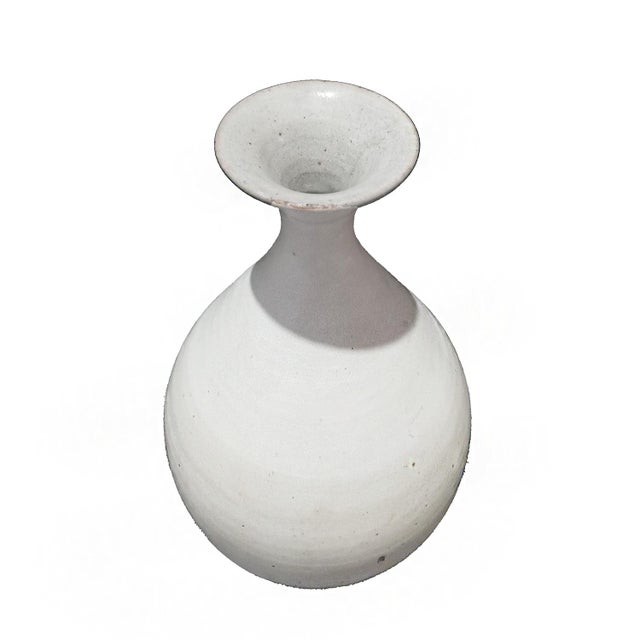 A ceramic vase from Thailand, with off-white glaze. Mid 20th Century, circa 1940. While the golden age of Thai ceramics...