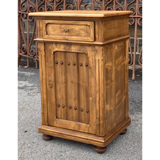 With the bold chamfered molding around the drawer front, which repeats in the door frame, with the two incised vertical...