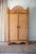 Presenting a 1970s Large Rattan Etched Wood Safari Arch Armoire Wardrobe Storage Cabinet. A striking piece that blends...