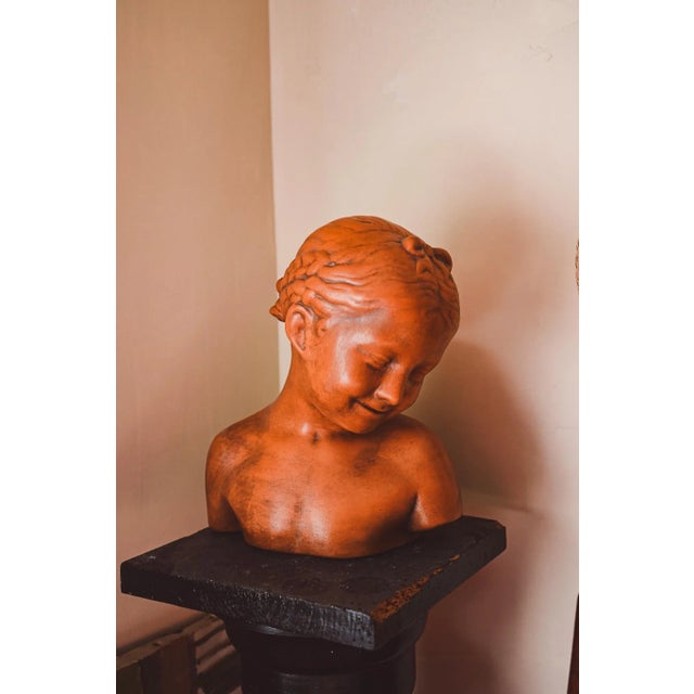 A few braids, a sincere yet shy smile. This terracotta bust is sweetness personified. It's a 1950s reproduction of a...