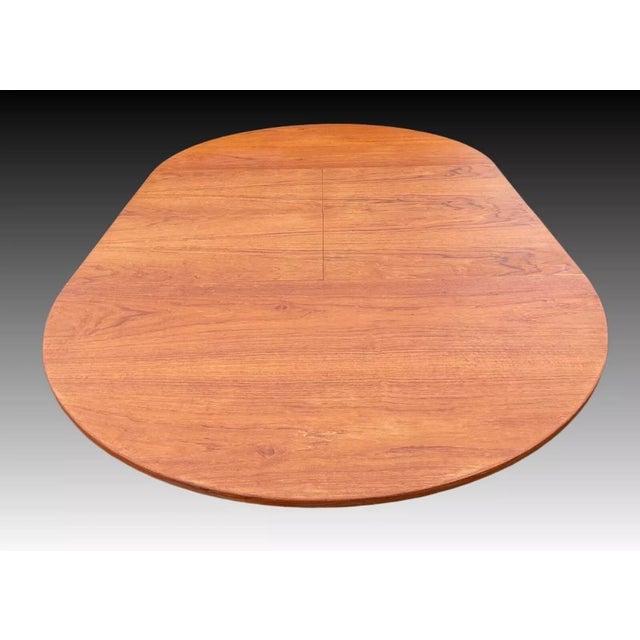 A danish rosewood circular extending draw leaf dining table, containing two folding leaves, on tapering supports, stamped...