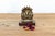 A masterfully cast micro-scale devotional shrine grouping featuring a central deity flanked by attendants beneath a multi-...