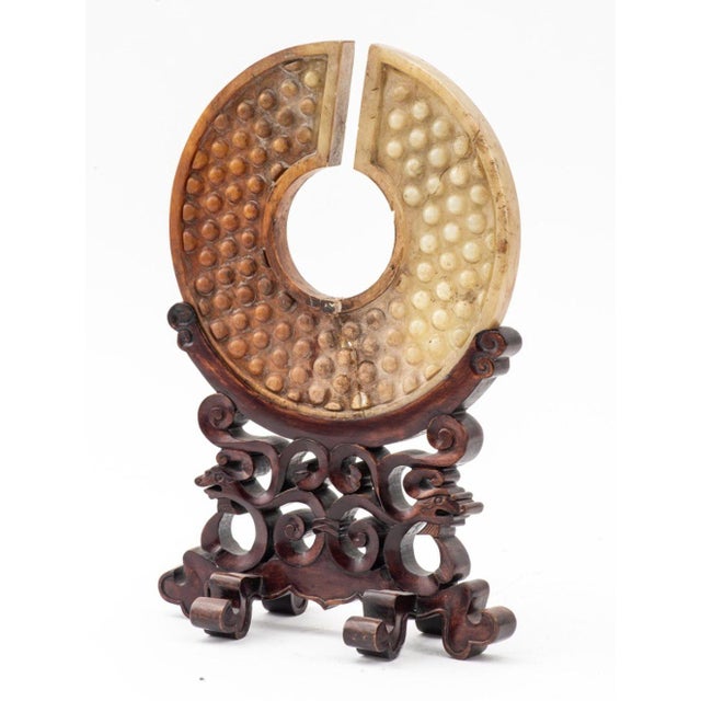 Chinese Carved Greenstone Bi Disc on Wood Stand, in an archaistic style, with a channel opening to a central hole and...