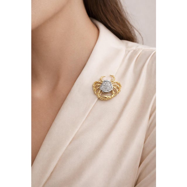 Distinctive crab-shaped brooch crafted in 18K yellow and white gold, featuring a textured sculptural design with...