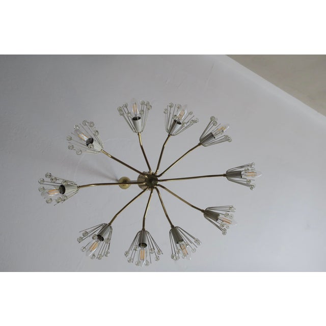 Unusual large fine and elegant brass and glass chandelier dating from the 1950s, probably Austrian or Italian. The...