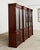 Opulent grand library bookcase cabinet crafted from mahogany in the English regency taste. The two-part case features...