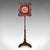 This is an antique pole screen. An English, rosewood and glass embroidered fireside heat reflector, dating to the William...