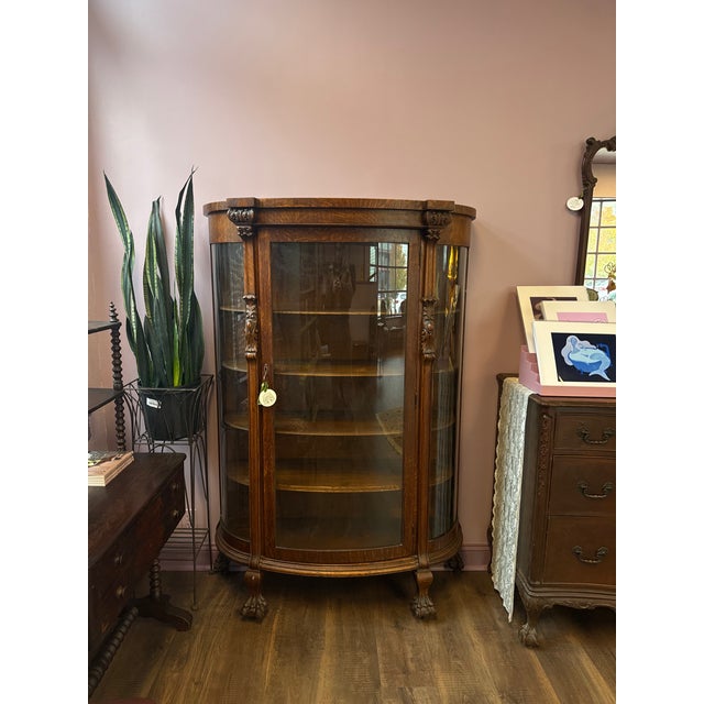 Beautiful Oak wood curved glass front China Cabinet. Door opens at the front. Glass all intact, no cracks. China Cabinet...