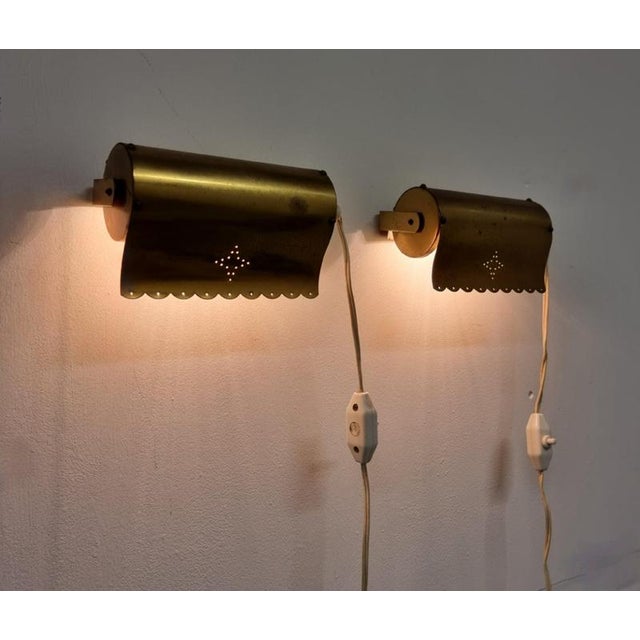 A pair of rare, charmig bed / wall lights in brass with perforated star pattern. Swedish / Scandinavian Modern, Mid-1900s....