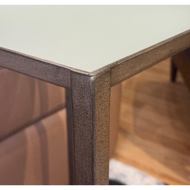 The 14-inch Wyland accent table features a metal base in a textured brass finish and an inset etched mirrored glass top....