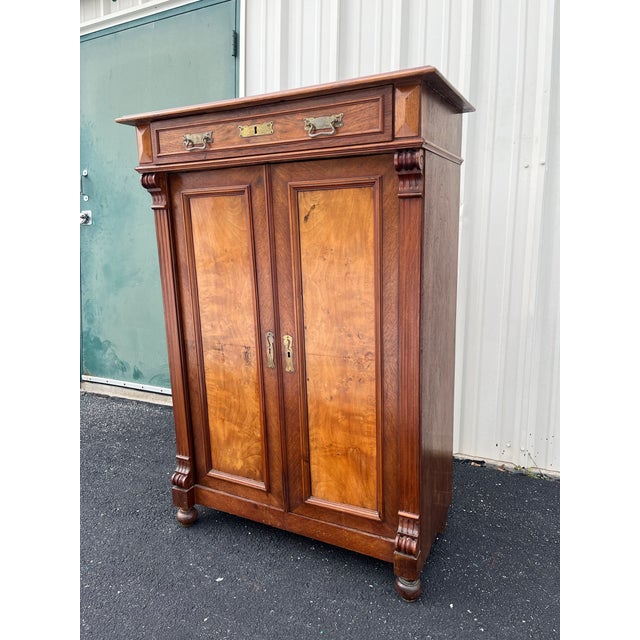 A 19th century burlwood chest of drawers or wardrobe dresser. Walnut and burlwood construction with clear indication of...