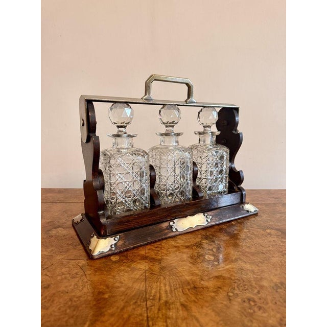 Wonderful antique oak three bottle tantalus, having a quality antique oak tantalus, with an oak frame and silver plated...