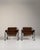 Pair of chrome-frame lounge chairs in Deep Espresso Brown. The deep espresso brown surface highlights tubular chrome...