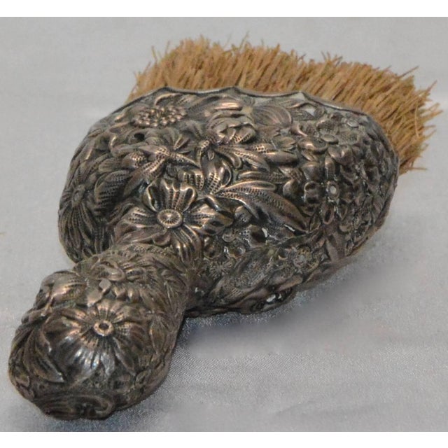 Beautiful flowers surround the handle on this Victorian crumb brush with scallops on the edge of the Sterling Silver. One...