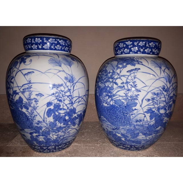 Magnificent pair of porcelain vases with rich underglaze blue decoration of a couple of partridges among the vegetation. A...