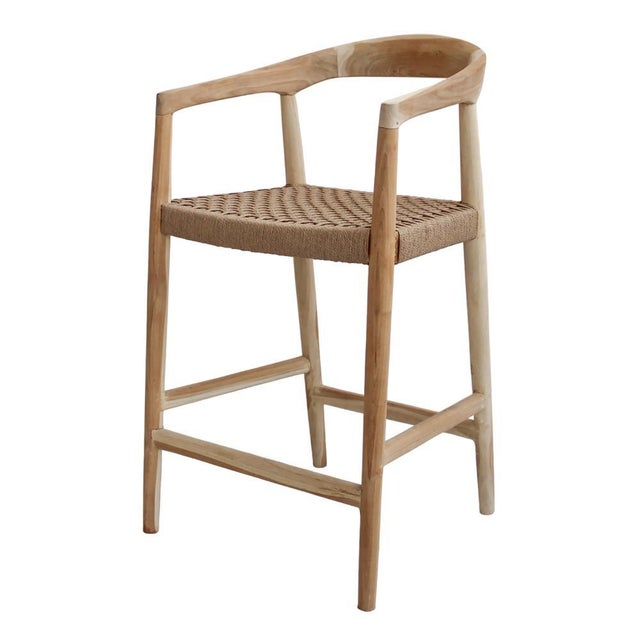 The Eijnar Natural Wooden Counter Stool delivers authentic rustic warmth with its plantation teak construction and...