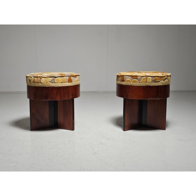 A pair of Art-deco style walnut veneer and floral-printed fabric (vanity) stools designed and produced in Italy, c. 1930s....