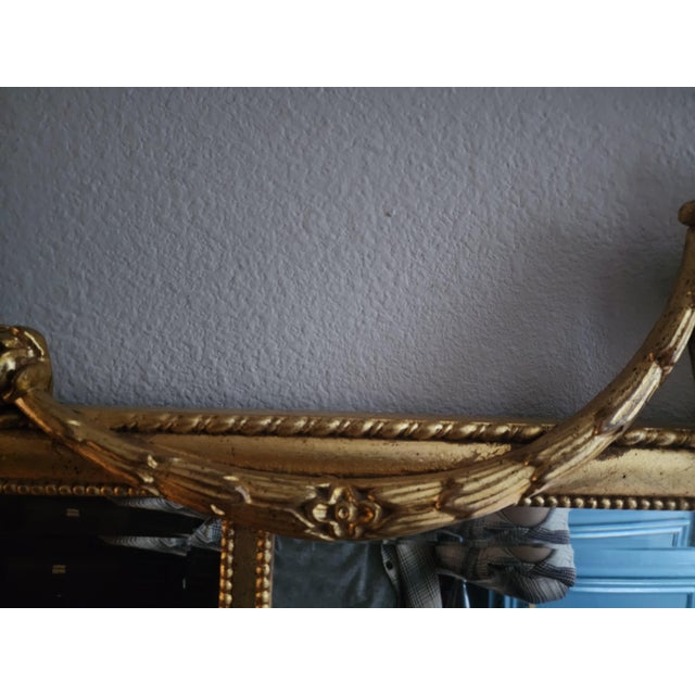 A stately and architectural vintage wall mirror by Ethan Allen, executed in the classic Federal or Adam style. This piece...