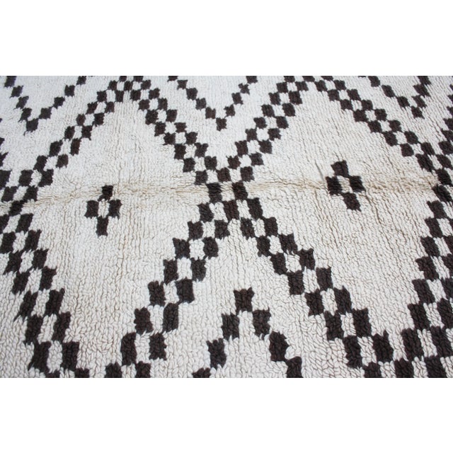 One-of-a-kind hand-knotted Moroccan rug in soft, organic wool with an ornate rhythmic pattern of diamond lozenge motif....