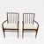 Set of two arm chairs in the style of T.H. Robsjohn Gibbings, in beautiful walnut and reupholstered in Dedar boucle. Clean...