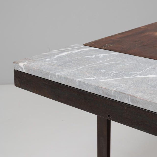 This 20th Century French industrial table embodies utilitarian design with an understated elegance. Constructed from dark...