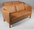 Arne Vodder two seat sofa in original light beige leather. Legs of oak. Made by Nielaus, model AV59 This piece is...