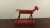 This is a wonderful piece of American Folk Art. This great little horse is painted red and leans forward with one leg off...