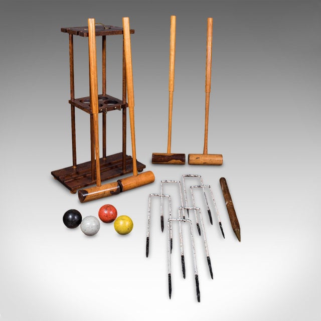 This is an antique vicarage croquet set. An English, country garden gaming stand, dating to the Edwardian period, circa...