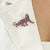 This panther brooch features 3.17 carats of round-cut rubies set in 925 sterling silver, accented by 0.18 carats of...