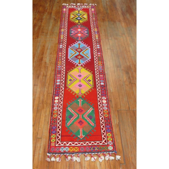 A funky colorful mid-20th century one of a kind Turkish runner woven in central Turkey. The weaver included longer fringes...