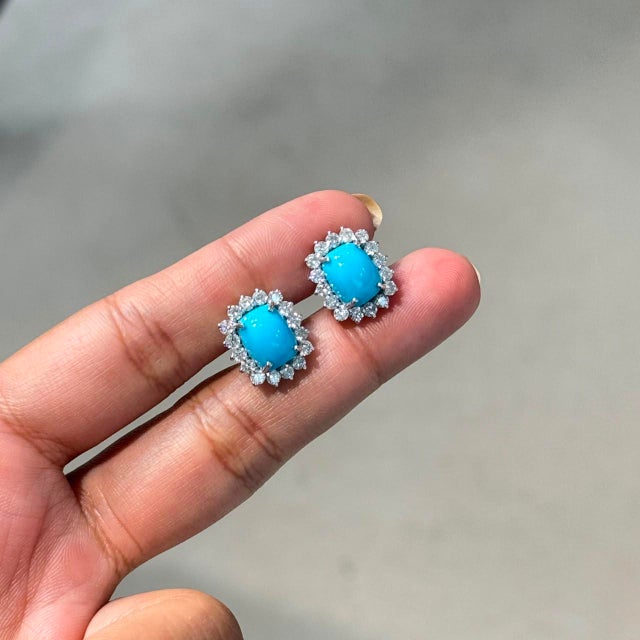 These vintage-inspired halo stud earrings feature 3.88 carats of turquoise, set in 14k white gold. Each turquoise...