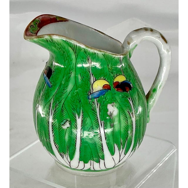 Adorable small creamer hand decorated with boc choy leaves and butterflies.