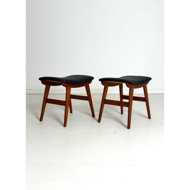 Teak Stool Pair – Black Leather, Danish, 1960s A refined pair of Danish stools from the 1960s, crafted with a solid teak...