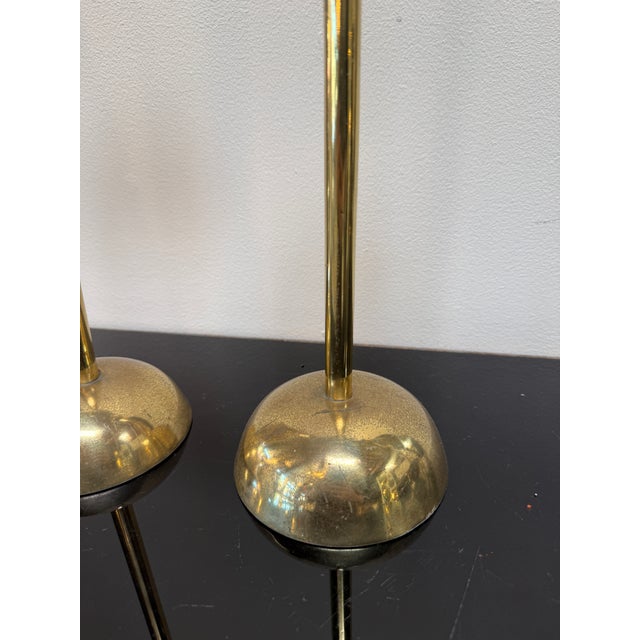 A refined pair of mid-century Italian candlesticks crafted in solid brass, distinguished by their elegant proportions and...