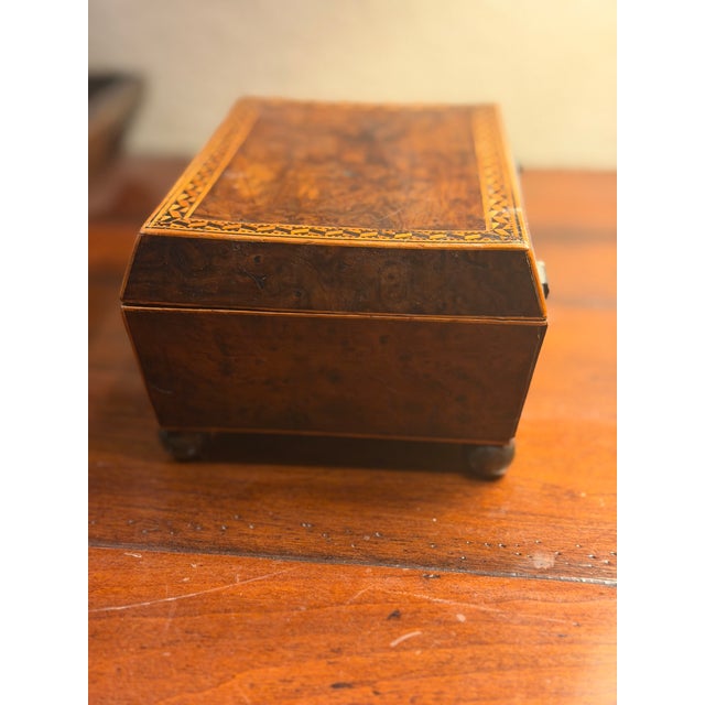 Likely 19th century Burl wood rectangular jewelry box. Hinged lid has an ivory colored, diamond shaped escutcheon. Missing...