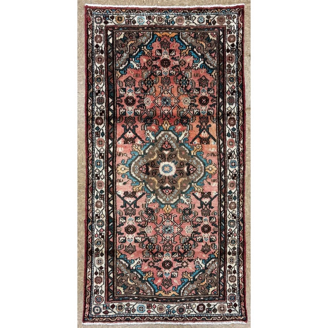 Hand-knotted village runner from the Hamadan region of western Iran, featuring a central medallion with stepped,...